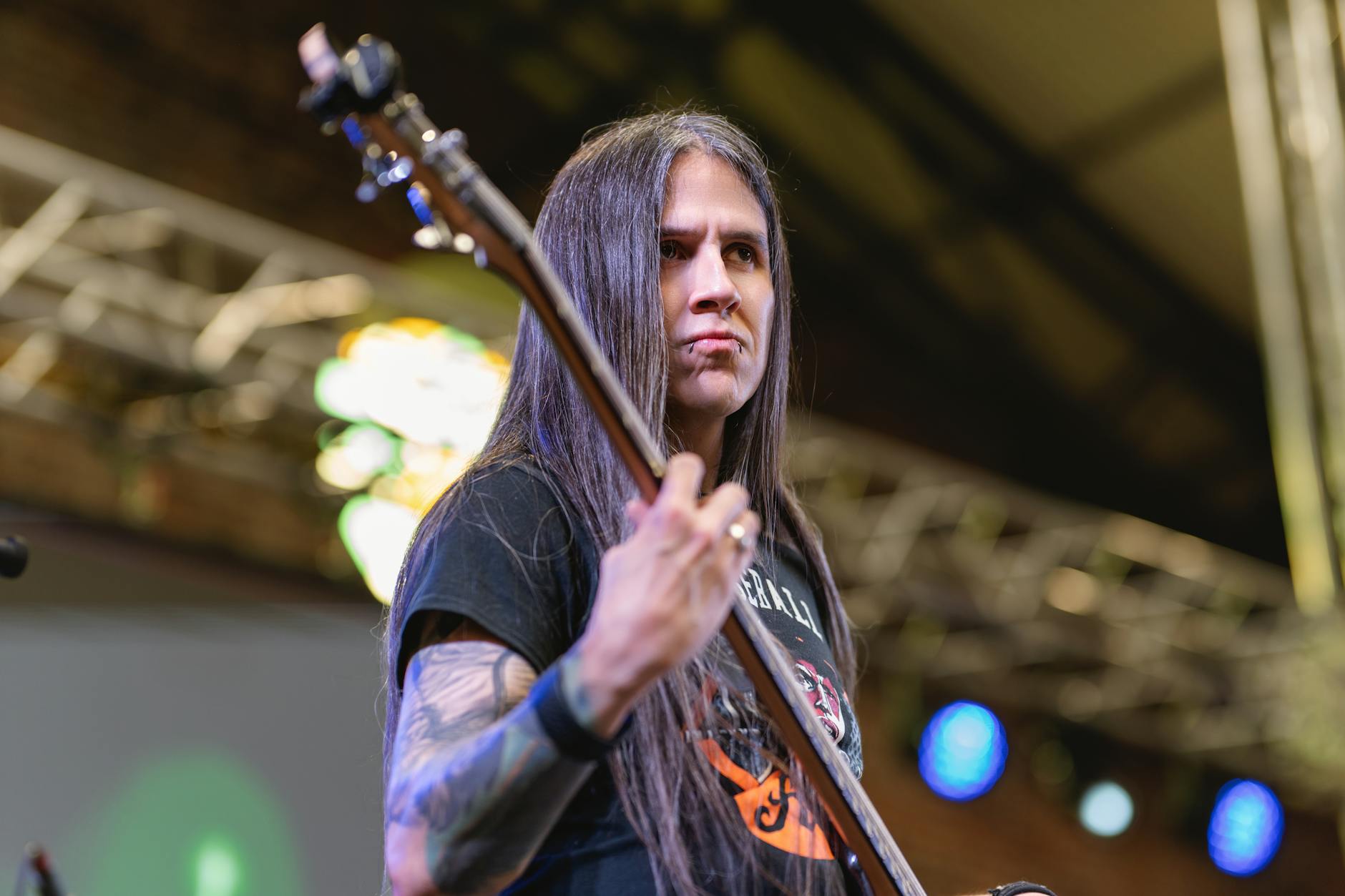 A guitarist performs live on stage at a vibrant concert in San José, Costa Rica.