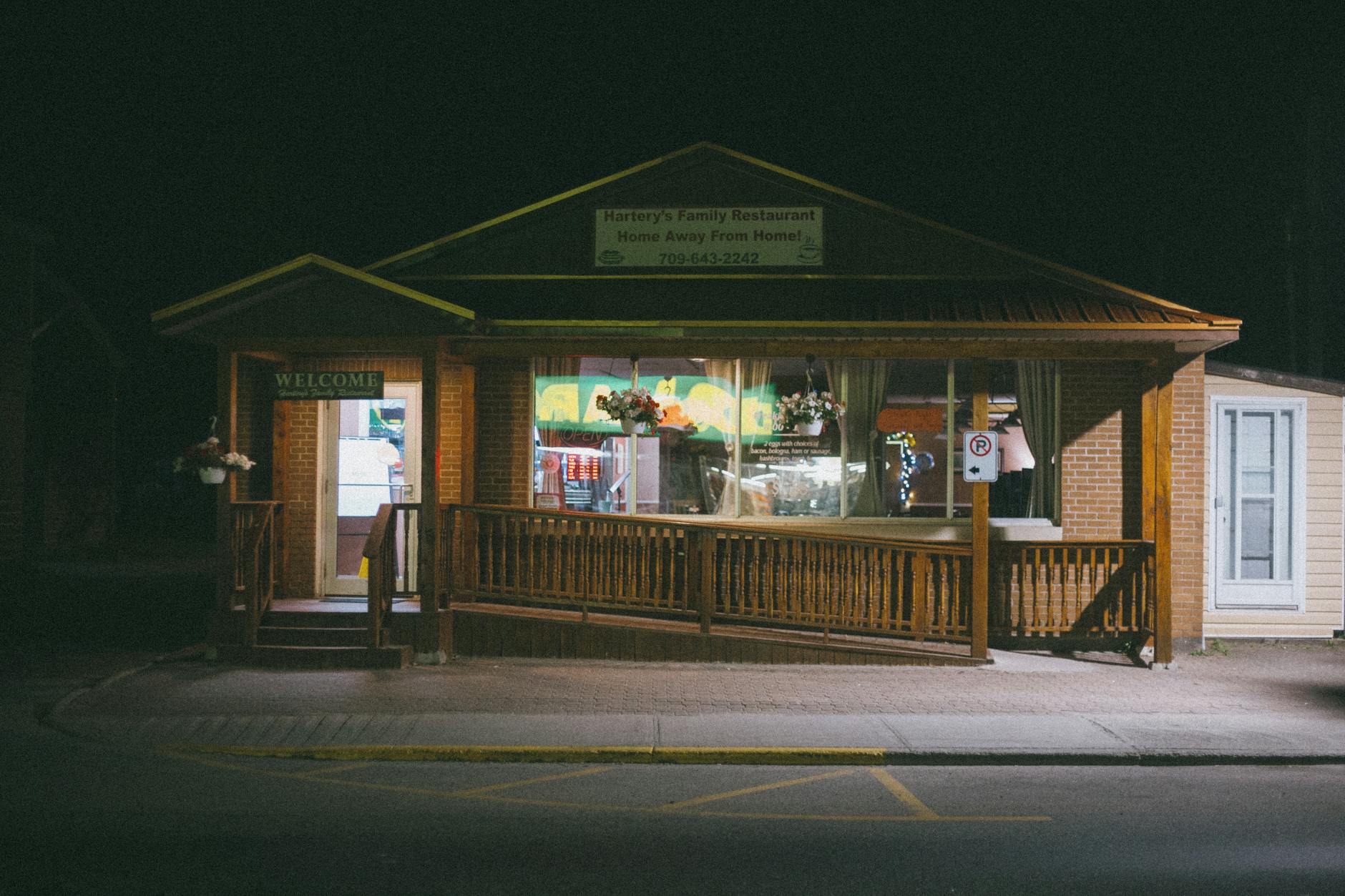 Cozy family restaurant illuminated at night, offering a warm welcome.