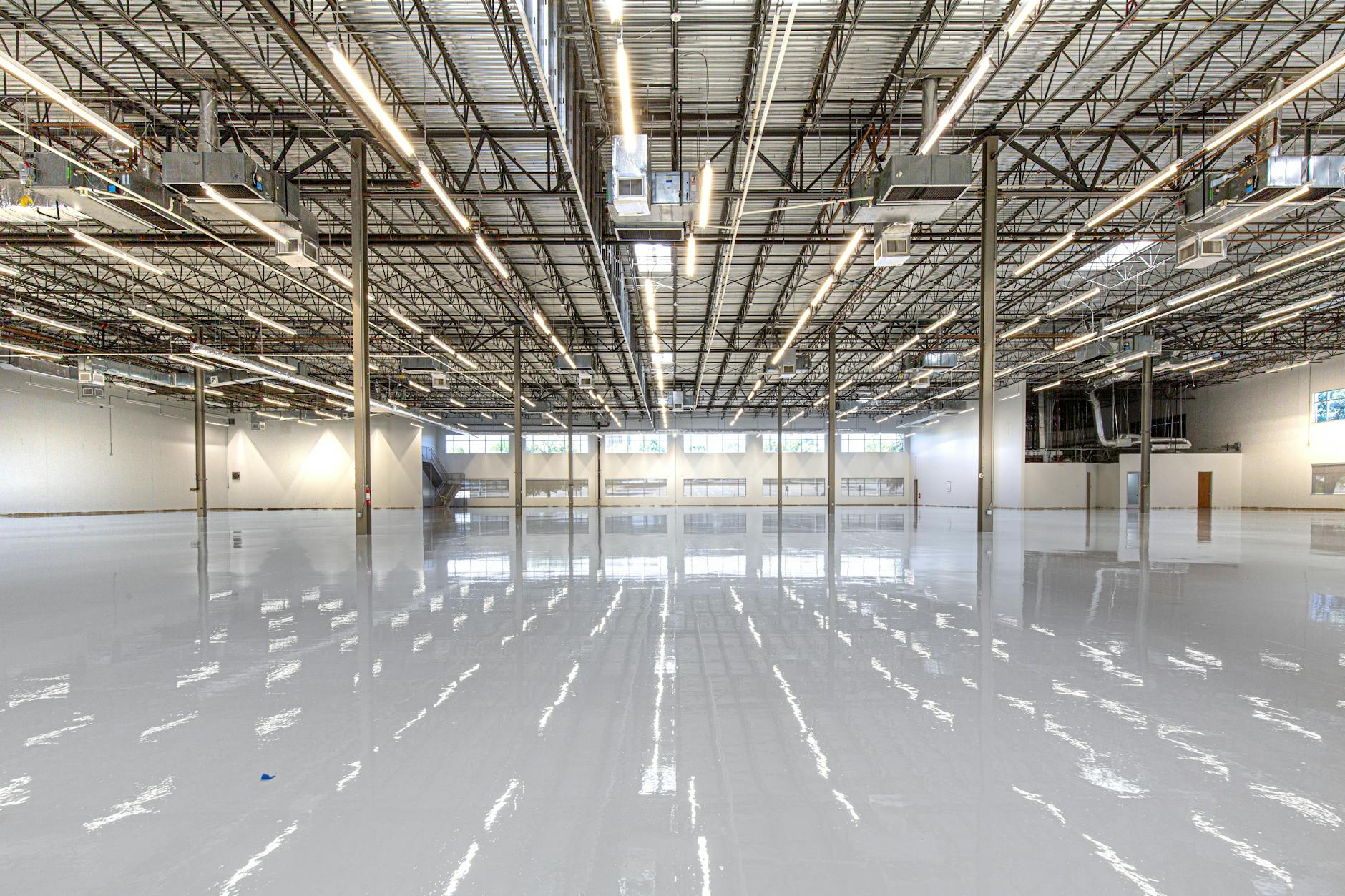Spacious and polished industrial facility with glossy epoxy flooring in Houston, Texas.